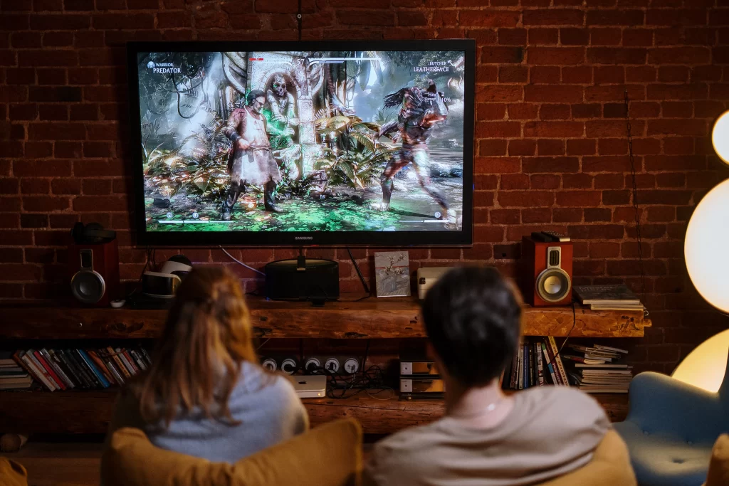 Couple playing video games on a tv in a gaming room