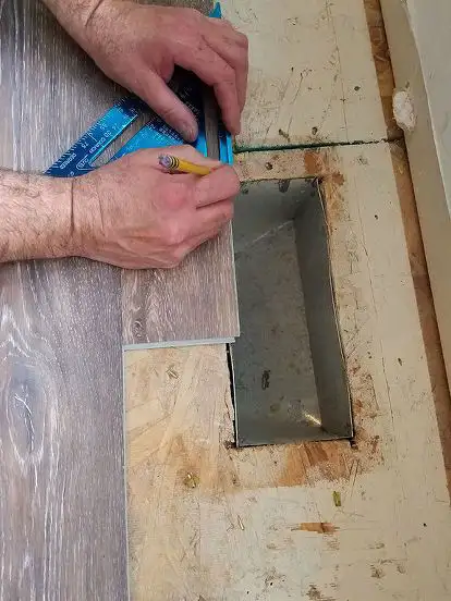 guy measuring vinyl flooring
