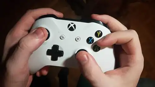 person holding an xbox controller with the claw grip