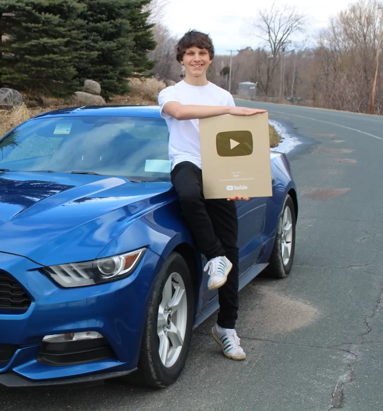 matt par leaning on his mustang with a 1M youtube play button