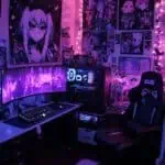 Goth gamer girl bedroom with dark decor and pink lighting accents.