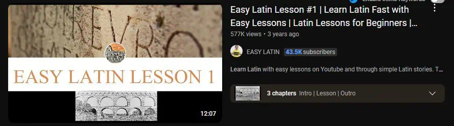 A YouTube video thumbnail with the text "EASY LATIN LESSON 1" overlaid on a background of Latin script carved into a stone wall. The video title reads "Easy Latin Lesson #1 | Learn Latin Fast with Easy Lessons | Latin Lessons for Beginners" by the channel EASY LATIN, which has 43.5K subscribers. The thumbnail suggests a beginner-friendly approach to learning Latin through simple lessons and visual aids.